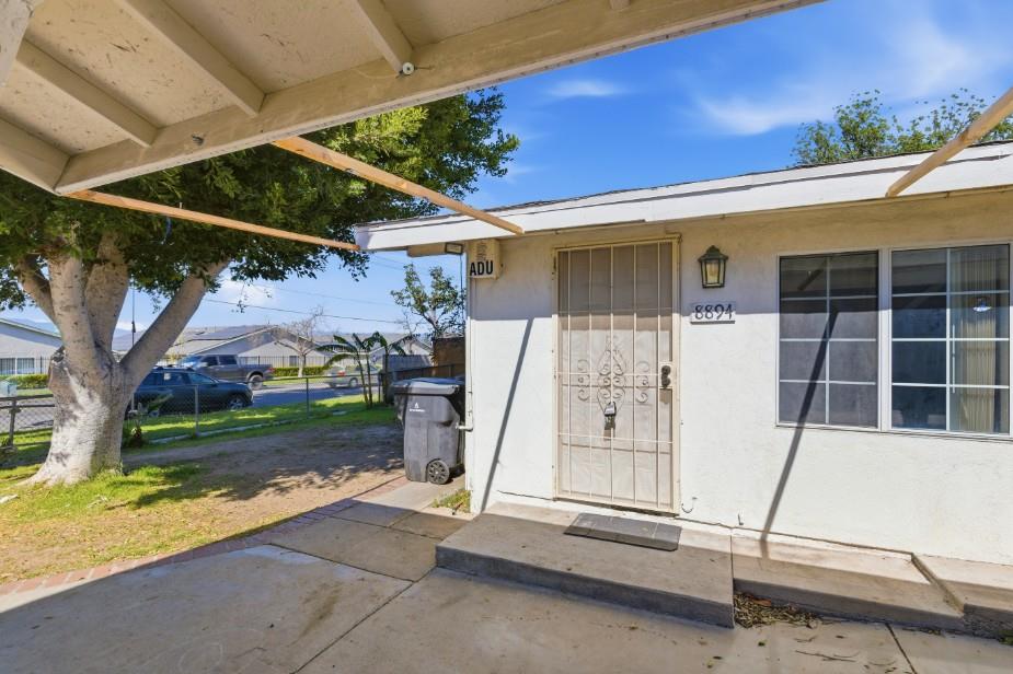 8894 Indiana Avenue Riverside, CA 92503 - Photo 13 of 16 a view of a house with a small yard and wooden fence