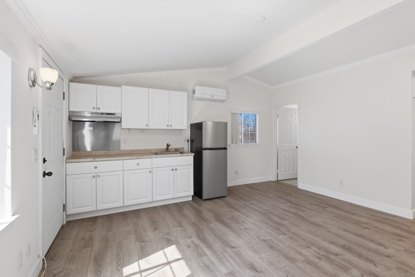 8894 Indiana Avenue Riverside, CA 92503 - Photo 7 of 16 a kitchen with stainless steel appliances granite countertop a refrigerator sink and white cabinets