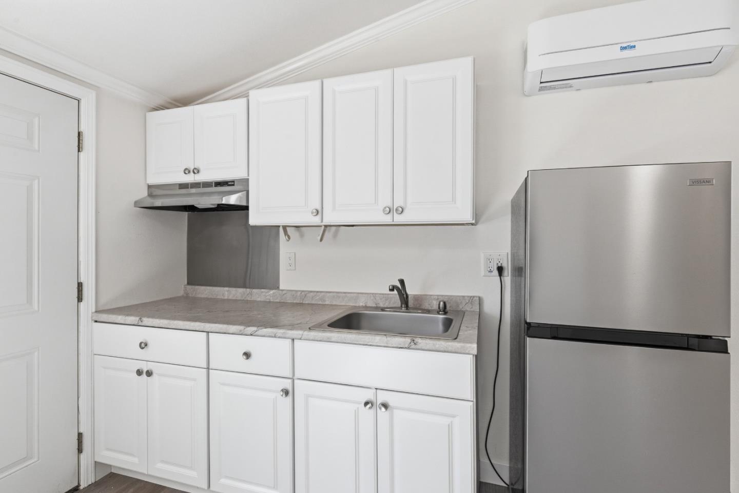 8894 Indiana Avenue Riverside, CA 92503 - Photo 9 of 16 a kitchen with a refrigerator and cabinets