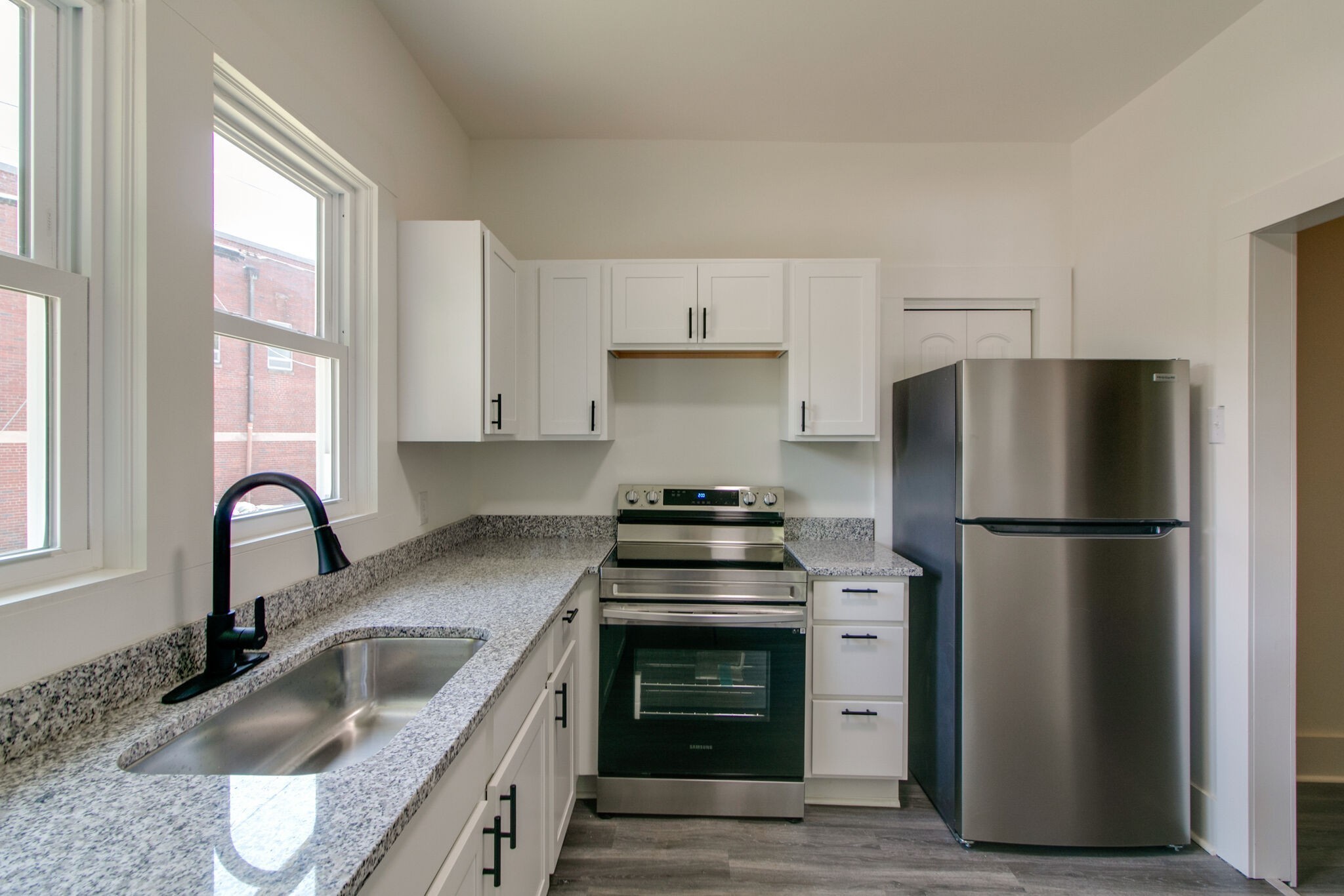 143 Emory Street, Unit C Clarksville, TN 37040 - Photo 4 of 13 a kitchen with a refrigerator stove and sink