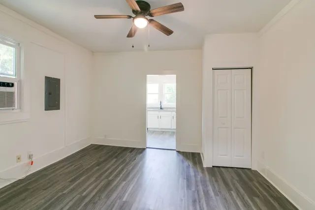 wooden floor in an empty room with a window