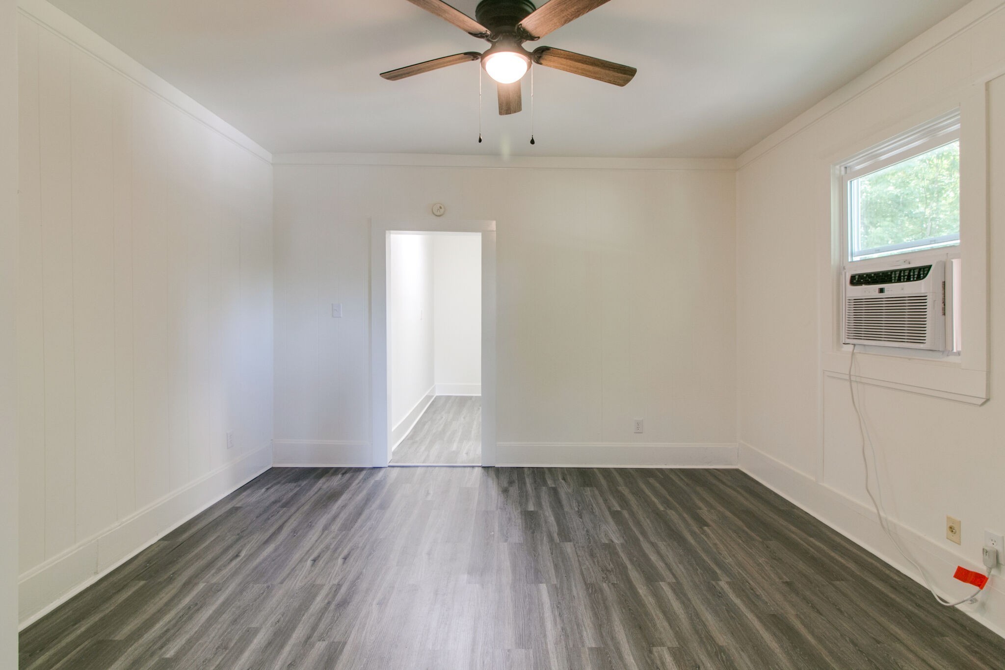 143 Emory Street, Unit C Clarksville, TN 37040 - Photo 7 of 13 wooden floor in an empty room with a window