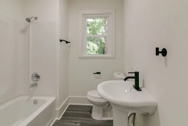 a bathroom with a sink a toilet and bathtub