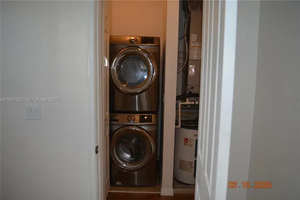 a view of a hallway with washer and dryer