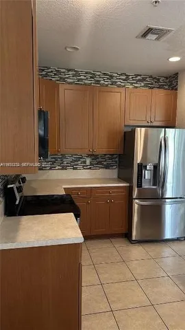 a kitchen with a sink a stove and refrigerator