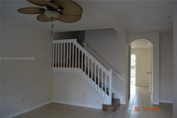 a view of staircase with lots of frames on wall and glass door
