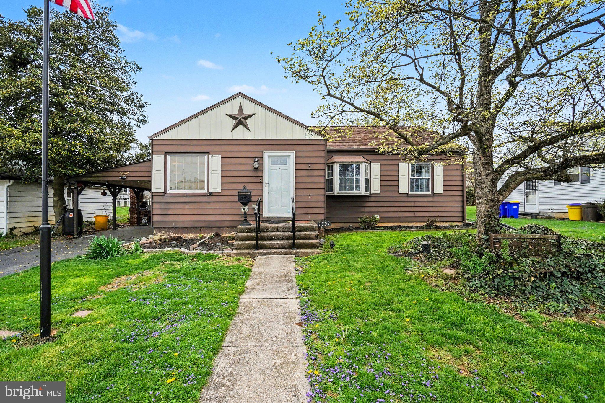 1309 Kingsley Road Camp Hill, PA 17011 - Photo 1 of 30 a front view of a house with a yard and potted plants