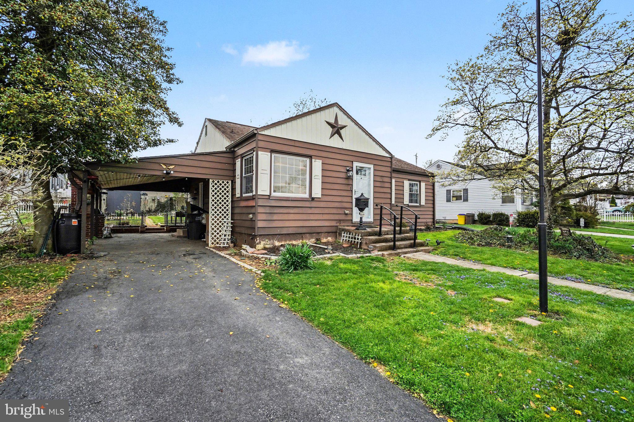 1309 Kingsley Road Camp Hill, PA 17011 - Photo 2 of 30 a front view of a house with a yard and garage