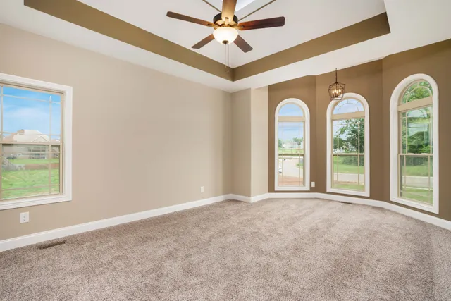 a view of a livingroom with a window and a ceiling fan