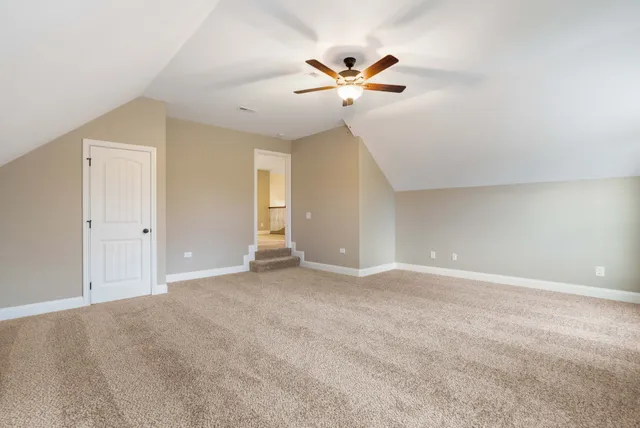 an empty room with closet and fan