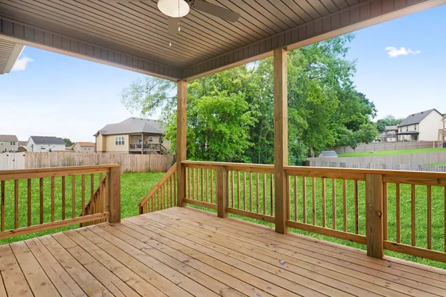 a white house that has a big yard and more windows