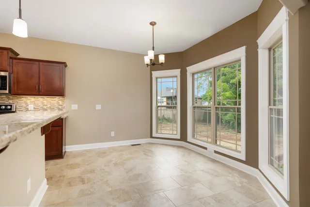 a view of kitchen with granite countertop cabinets and outdoor space