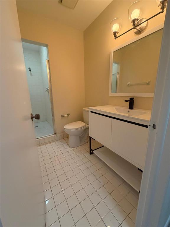 7410 Woodmont Terrace, Unit 207 Tamarac, FL 33321 - Photo 12 of 20 a bathroom with a sink a toilet and a mirror