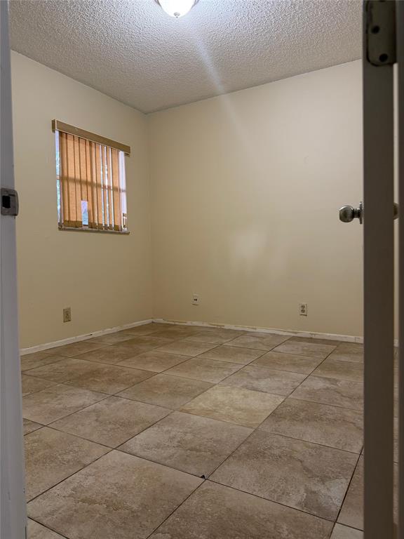 7410 Woodmont Terrace, Unit 207 Tamarac, FL 33321 - Photo 14 of 20 a view of an empty room with a window