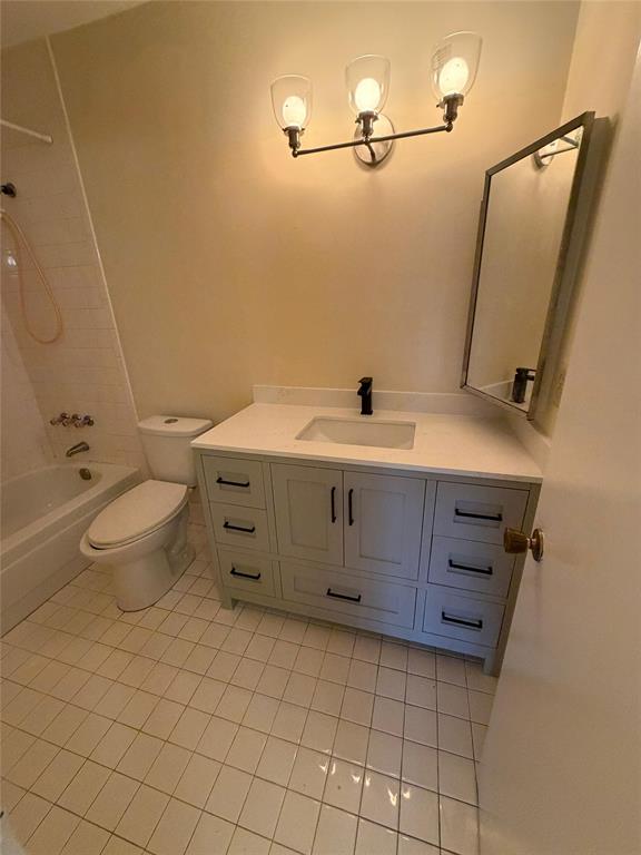 7410 Woodmont Terrace, Unit 207 Tamarac, FL 33321 - Photo 18 of 20 a bathroom with a sink a toilet and mirror