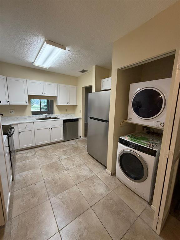 7410 Woodmont Terrace, Unit 207 Tamarac, FL 33321 - Photo 4 of 20 a kitchen with a refrigerator and a sink