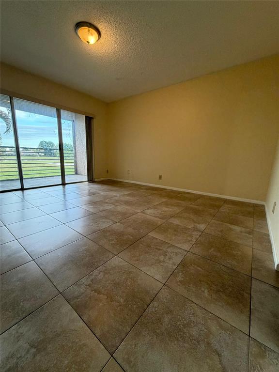 7410 Woodmont Terrace, Unit 207 Tamarac, FL 33321 - Photo 8 of 20 a view of an empty room with a window