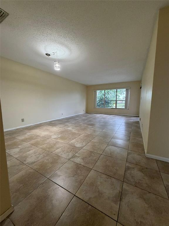 7410 Woodmont Terrace, Unit 207 Tamarac, FL 33321 - Photo 9 of 20 a view of an empty room with a window