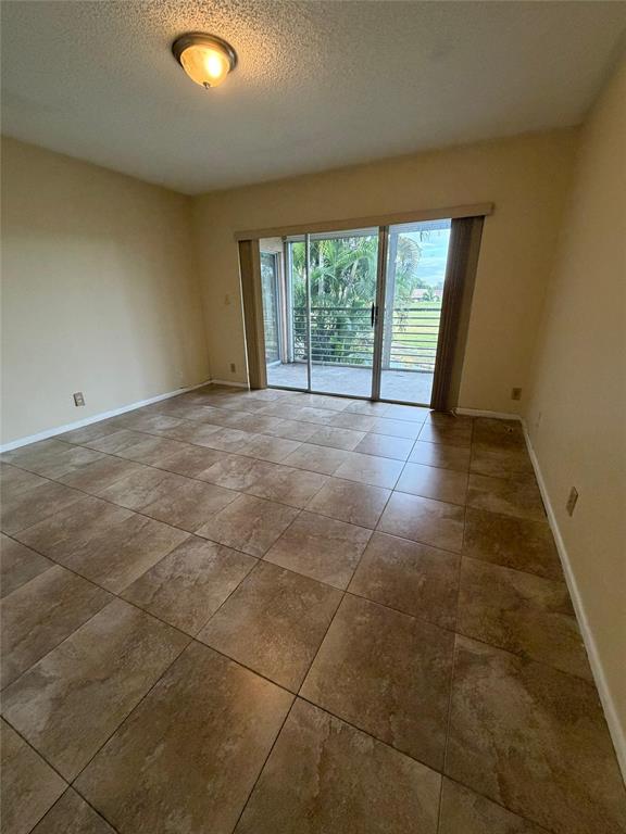 7410 Woodmont Terrace, Unit 207 Tamarac, FL 33321 - Photo 10 of 20 a view of an empty room with a window