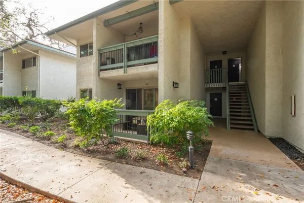 a house with potted plants in front of door