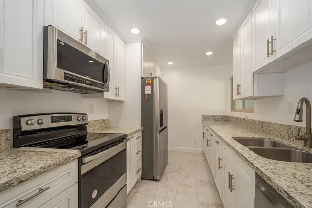a kitchen with a sink stove and microwave