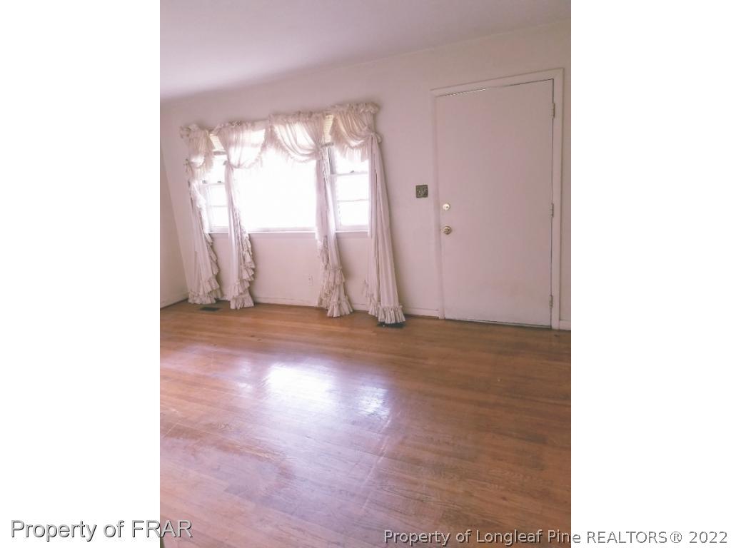 3913 Cumberland Road Fayetteville, NC 28306 - Photo 9 of 13 a view of empty room with wooden floor and fan