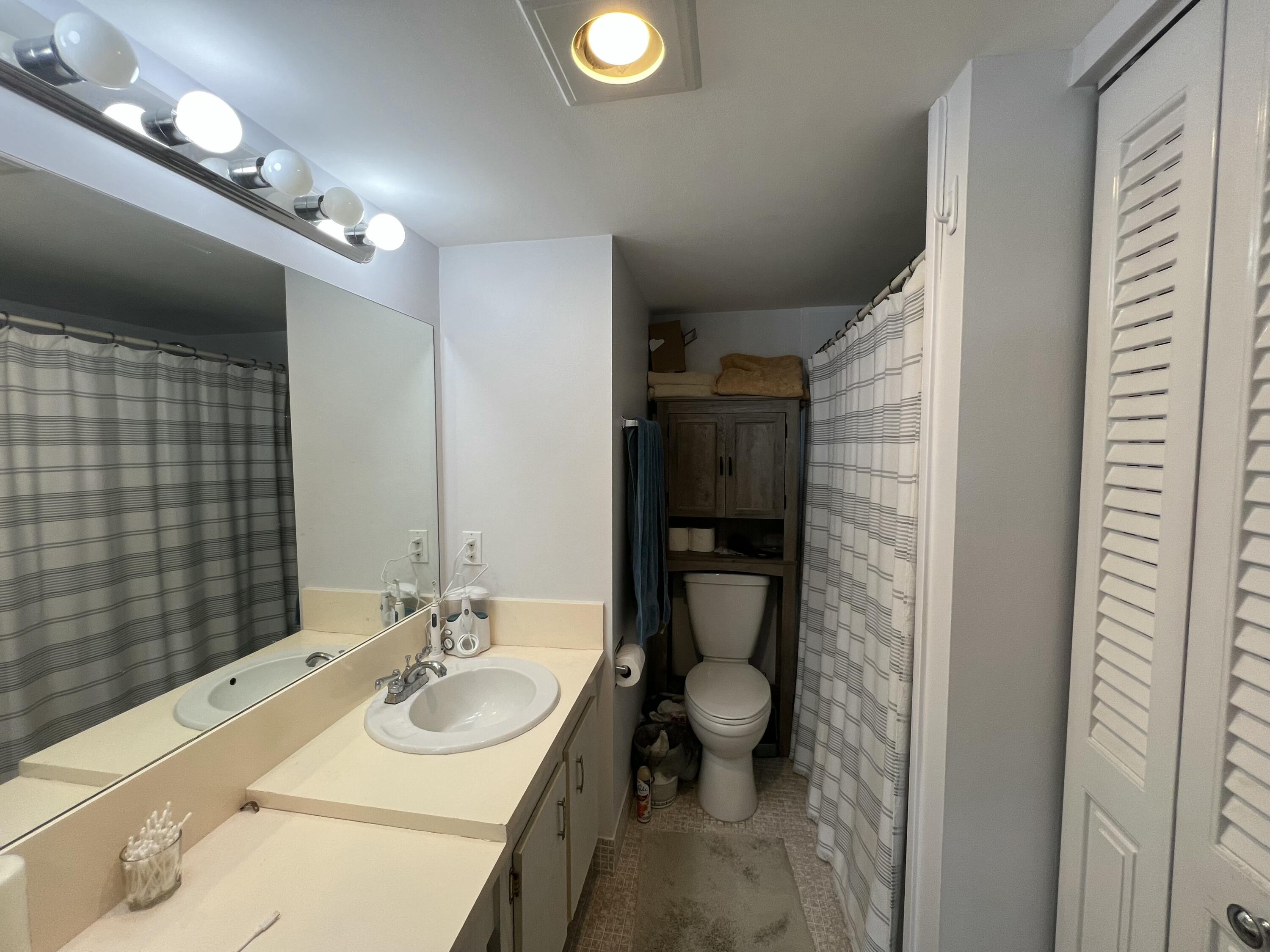 2038 Hythe A Boca Raton, FL 33434 - Photo 12 of 15 a bathroom with a sink toilet and shower