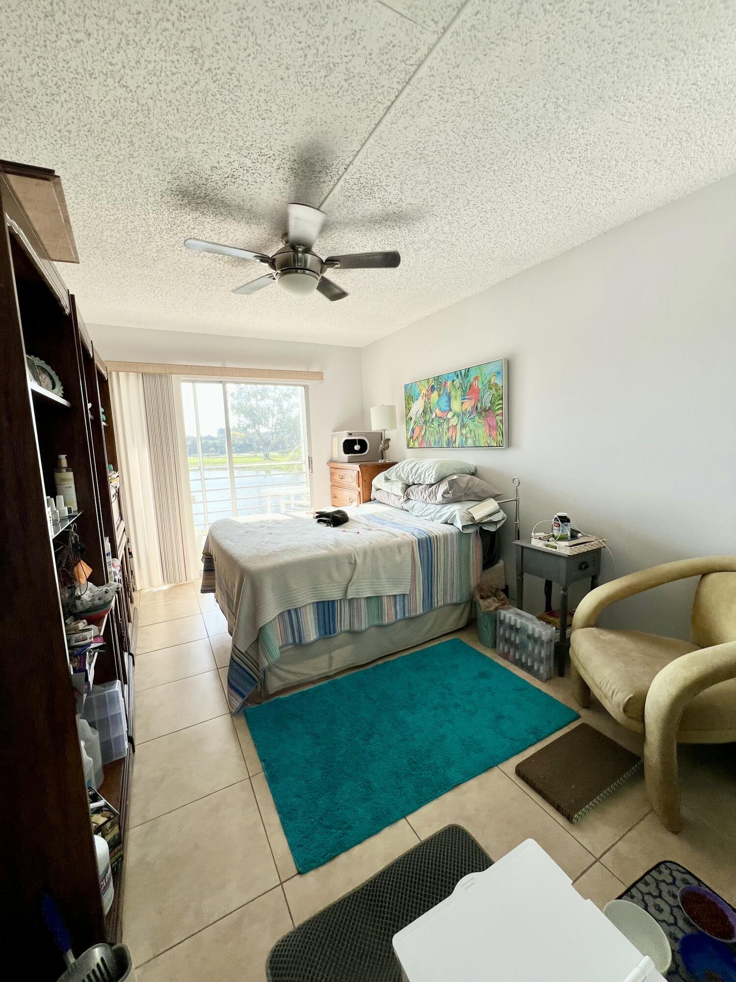 2038 Hythe A Boca Raton, FL 33434 - Photo 14 of 15 a bedroom with a bed a couch and a window