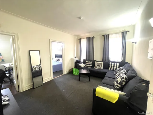 a dining room with furniture entryway and wooden floor