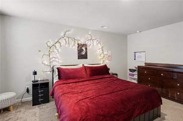 a bed room with a bed and a dresser
