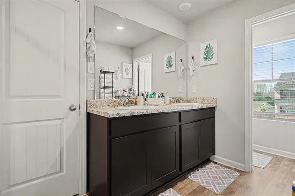 a bathroom with a granite countertop sink a toilet and a mirror