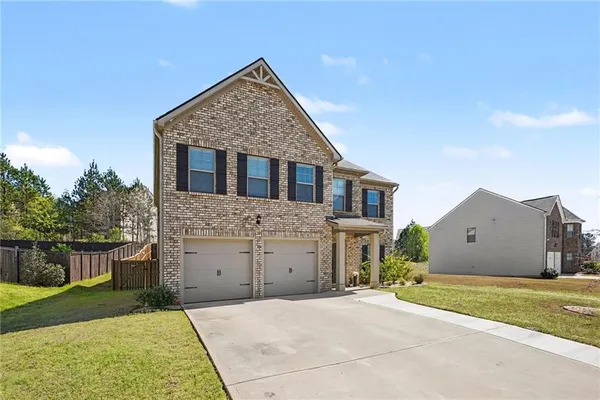 a front view of a house with a yard