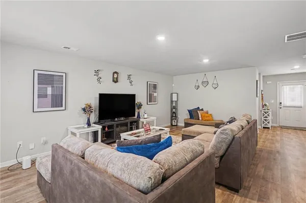 a view of a dining room with furniture and wooden floor