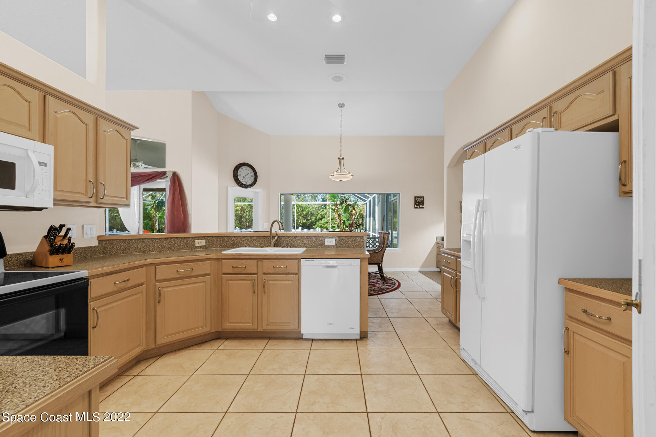3650 Shady Run Road Melbourne, FL 32934 - Photo 12 of 43 a kitchen with a refrigerator and a sink