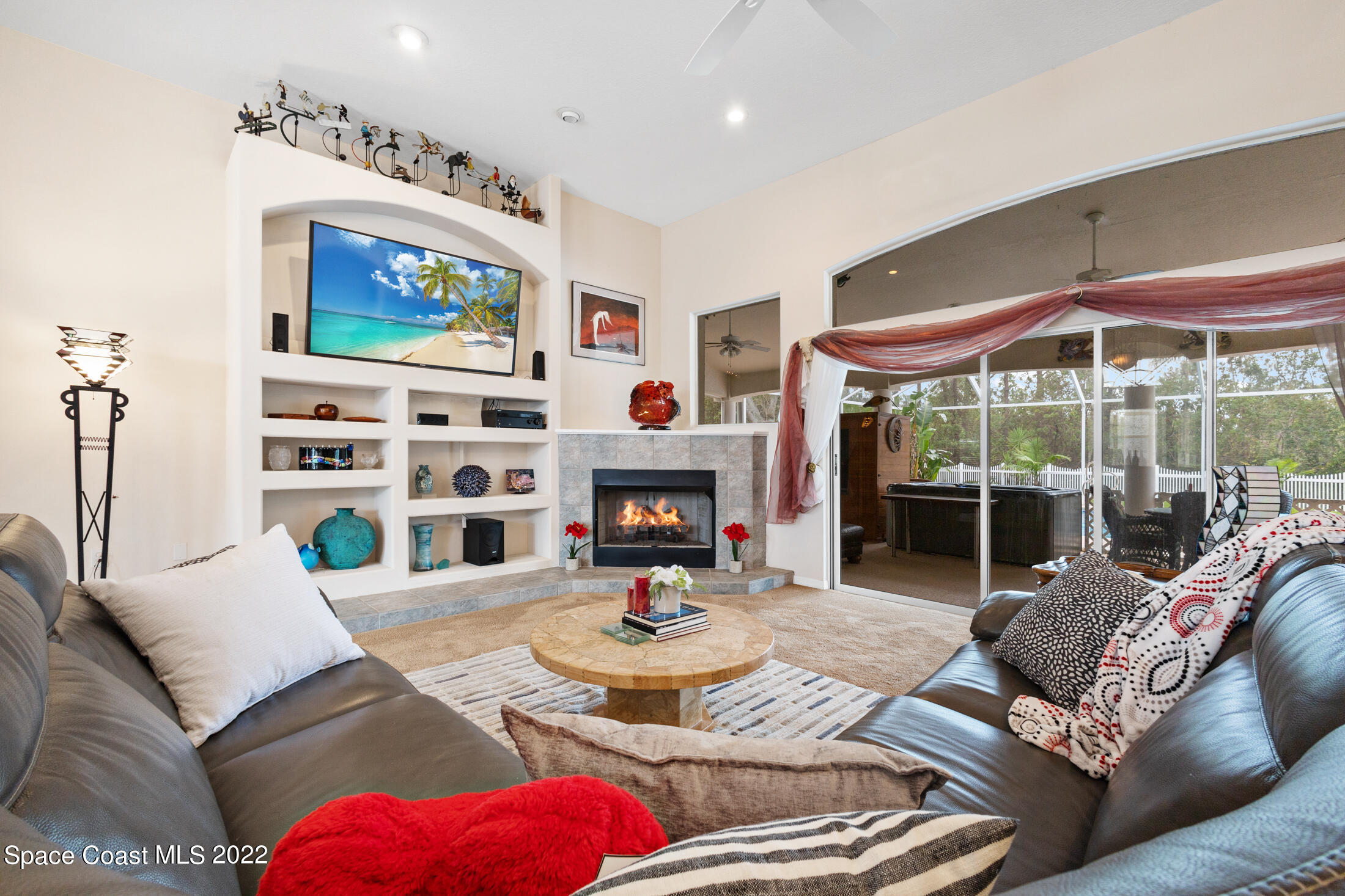 3650 Shady Run Road Melbourne, FL 32934 - Photo 9 of 43 a living room with furniture a fireplace and a flat screen tv