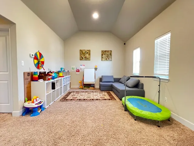 a living room with furniture a baby crib furniture and a table