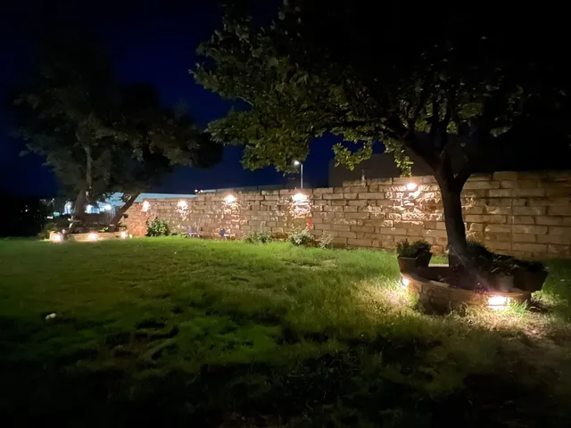 a view of a yard with table and chairs a fire pit and plants