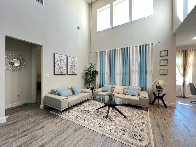 a living room with furniture and wooden floor
