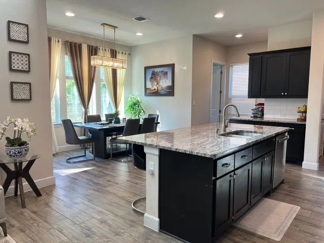 a kitchen with granite countertop lots of counter top space and dining table
