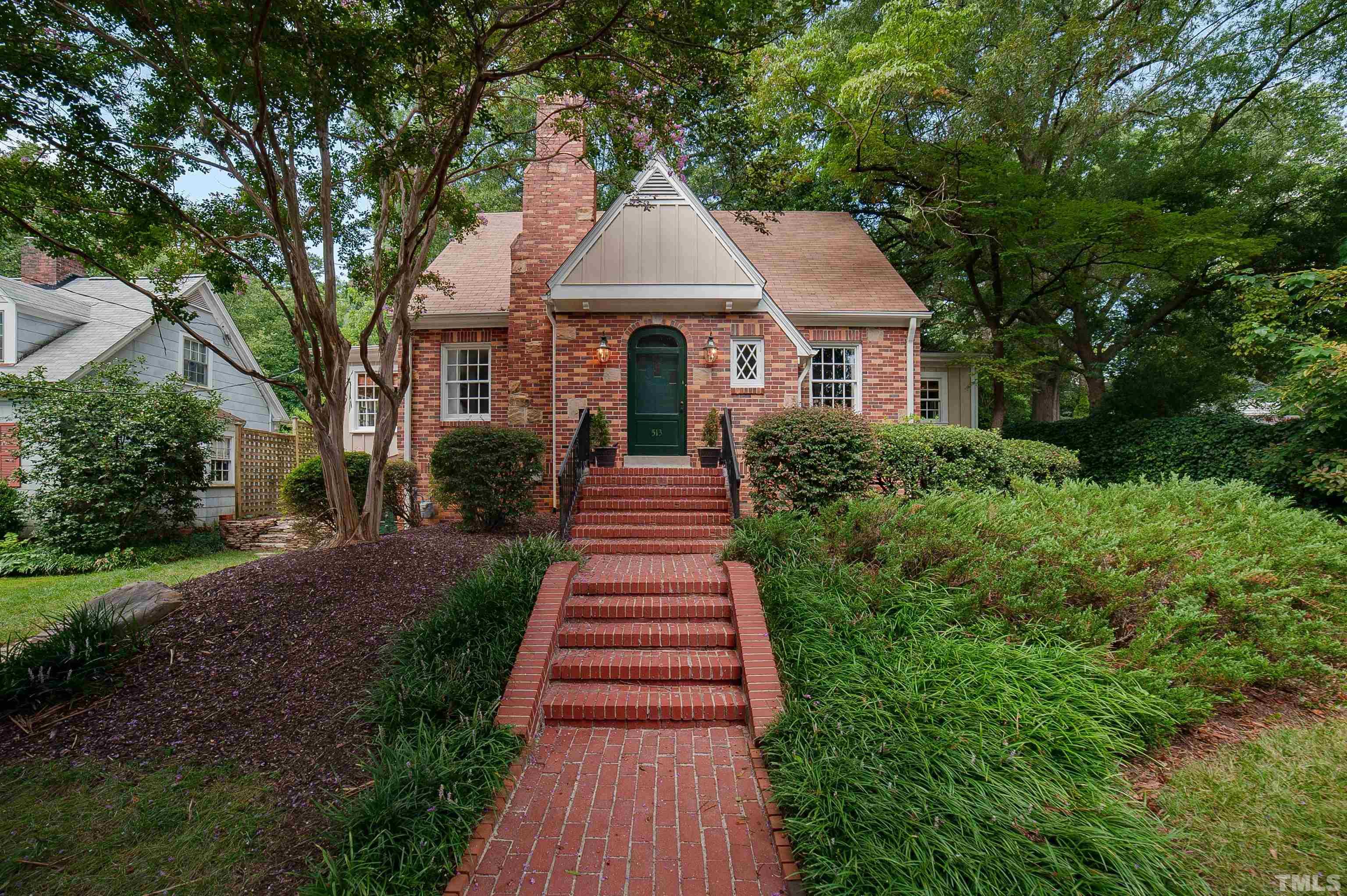 513 Gardner Street Raleigh, NC 27607 - Photo 1 of 56 a front view of a house with a garden