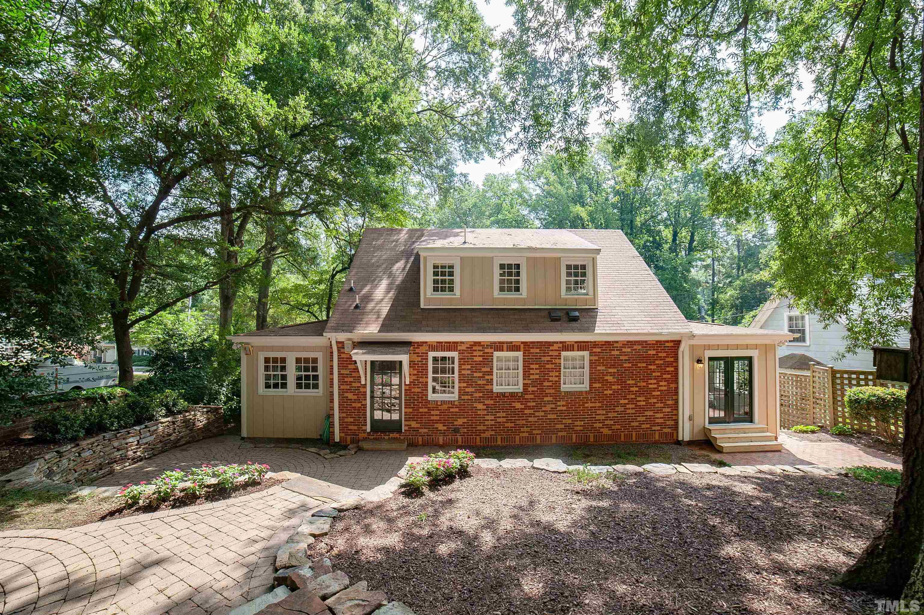 513 Gardner Street Raleigh, NC 27607 - Photo 55 of 56 a front view of a house with a garden