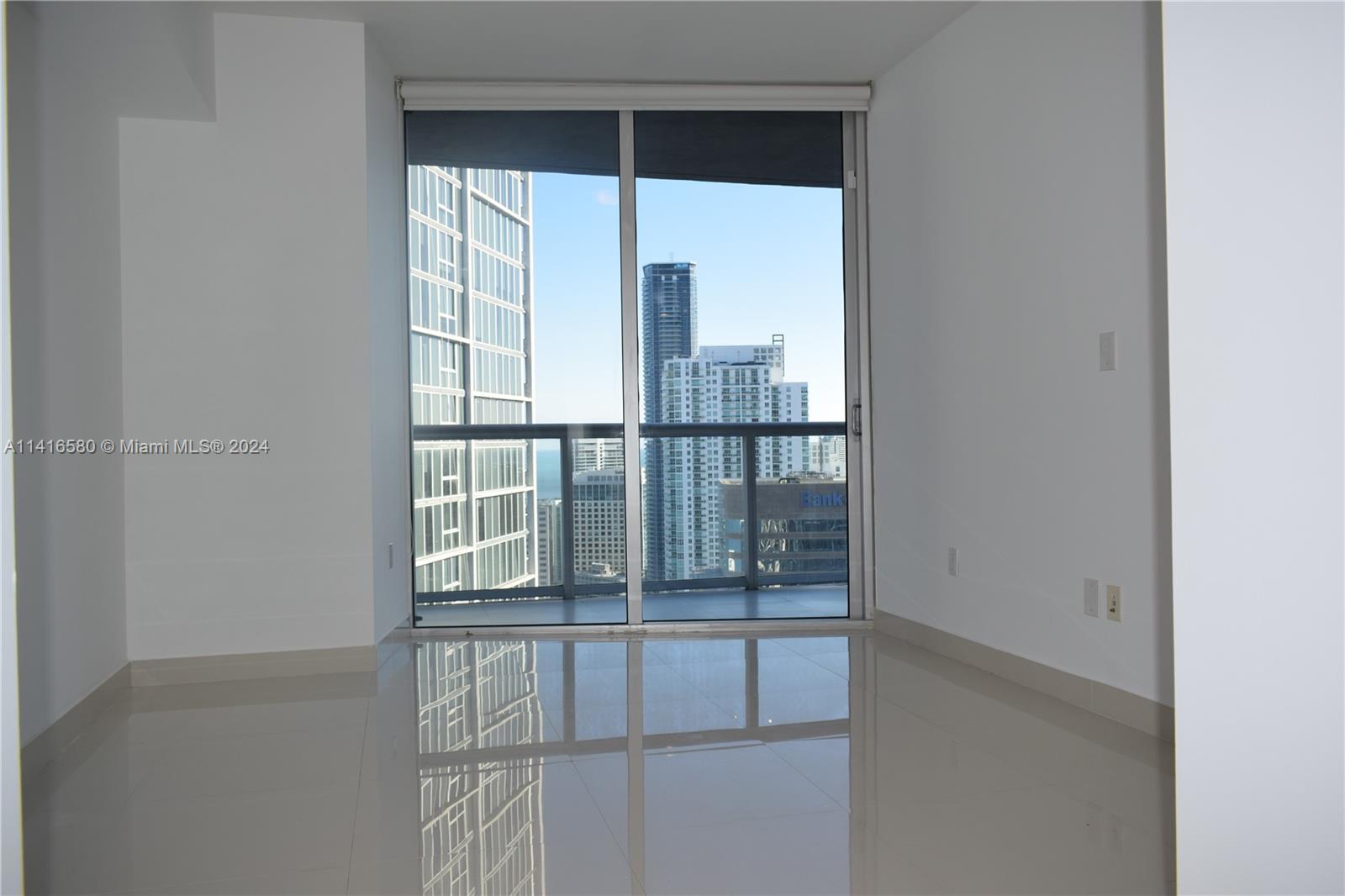 475 Brickell Avenue, Unit 4613 Miami, FL 33131 - Photo 7 of 30 a view of an empty room with wooden floor and a window