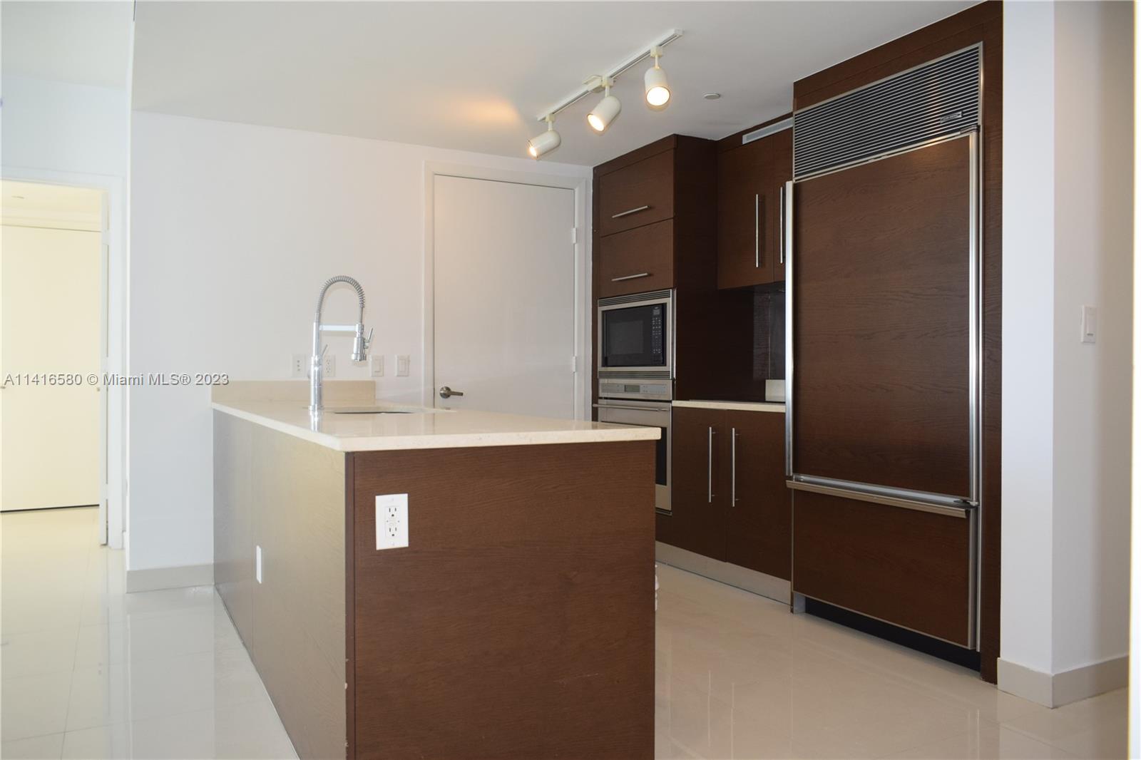 475 Brickell Avenue, Unit 4613 Miami, FL 33131 - Photo 9 of 30 a kitchen with stainless steel appliances granite countertop a refrigerator and a sink