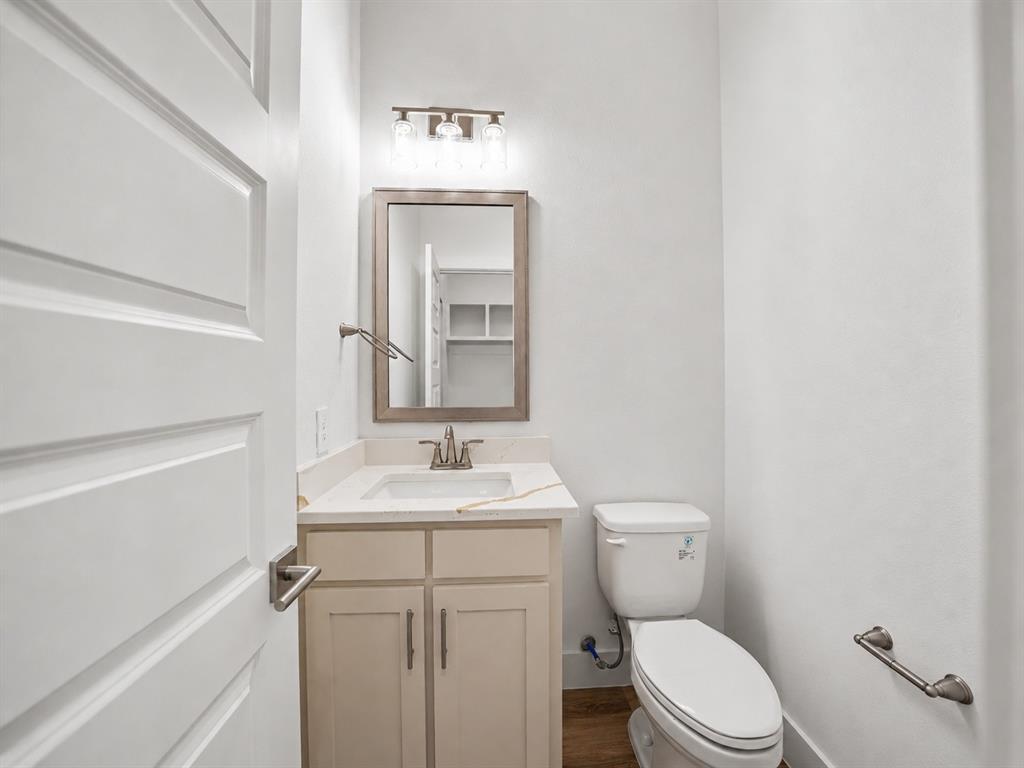 328 Slimp Bluff Azle, TX 76020 - Photo 27 of 30 Bathroom featuring a vanity with an undermount sink, countertop, and a framed mirror