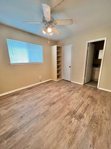 a view of walk in closet with wooden floor