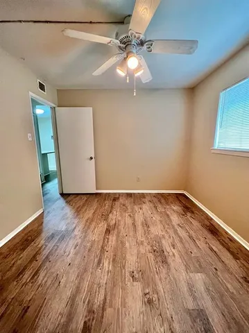 a view of a room with wooden floor and brick wall