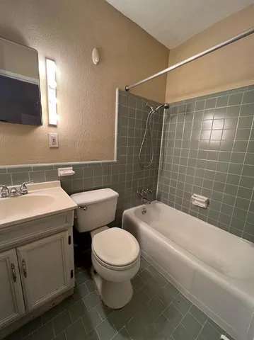 a view of a room with wooden floor and white walls