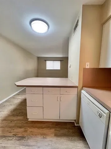 a view of a kitchen with a sink and a refrigerator