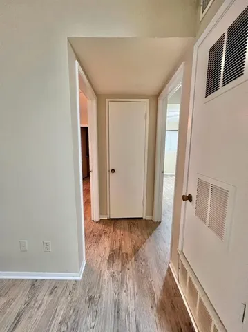 a view of a room with wooden floor and a window