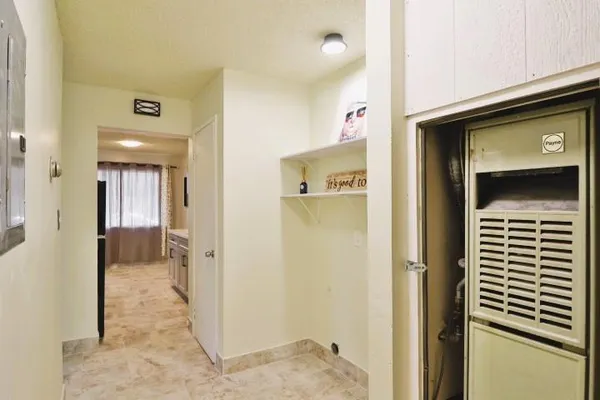 a view of a hallway with wooden shelves